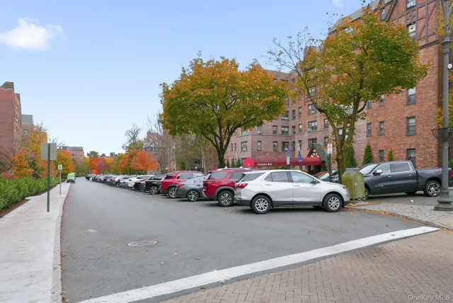 a view of cars parked on the side of a street
