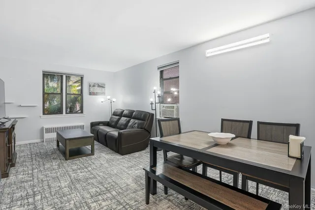 a view of a livingroom with furniture and a window