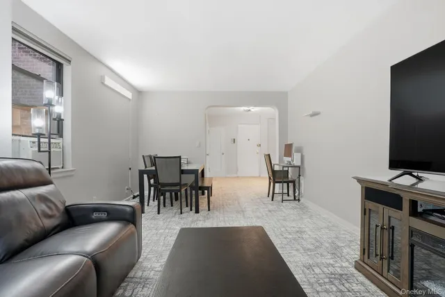 a living room with furniture a dining table and a piano