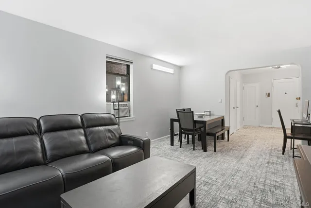 a living room with furniture a dining table and a piano table
