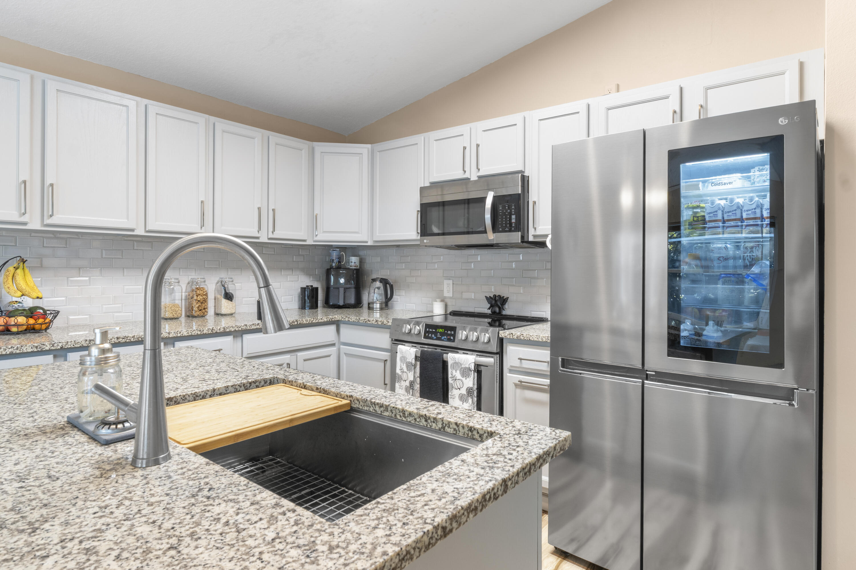 789 Vocelle Avenue Sebastian, FL 32958 - Photo 11 of 37 a kitchen with stainless steel appliances granite countertop a sink stove and refrigerator