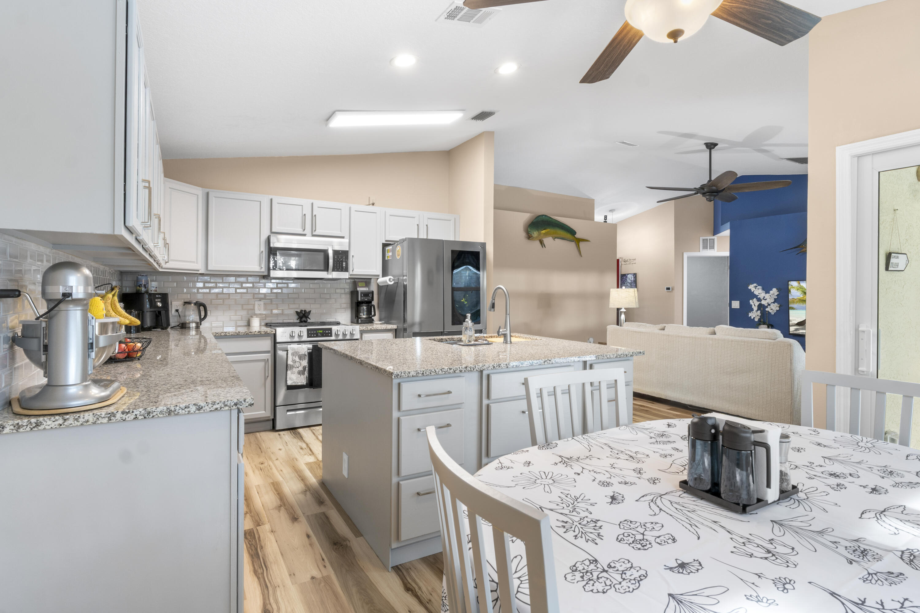 789 Vocelle Avenue Sebastian, FL 32958 - Photo 14 of 37 a kitchen with sink refrigerator dining table and chairs