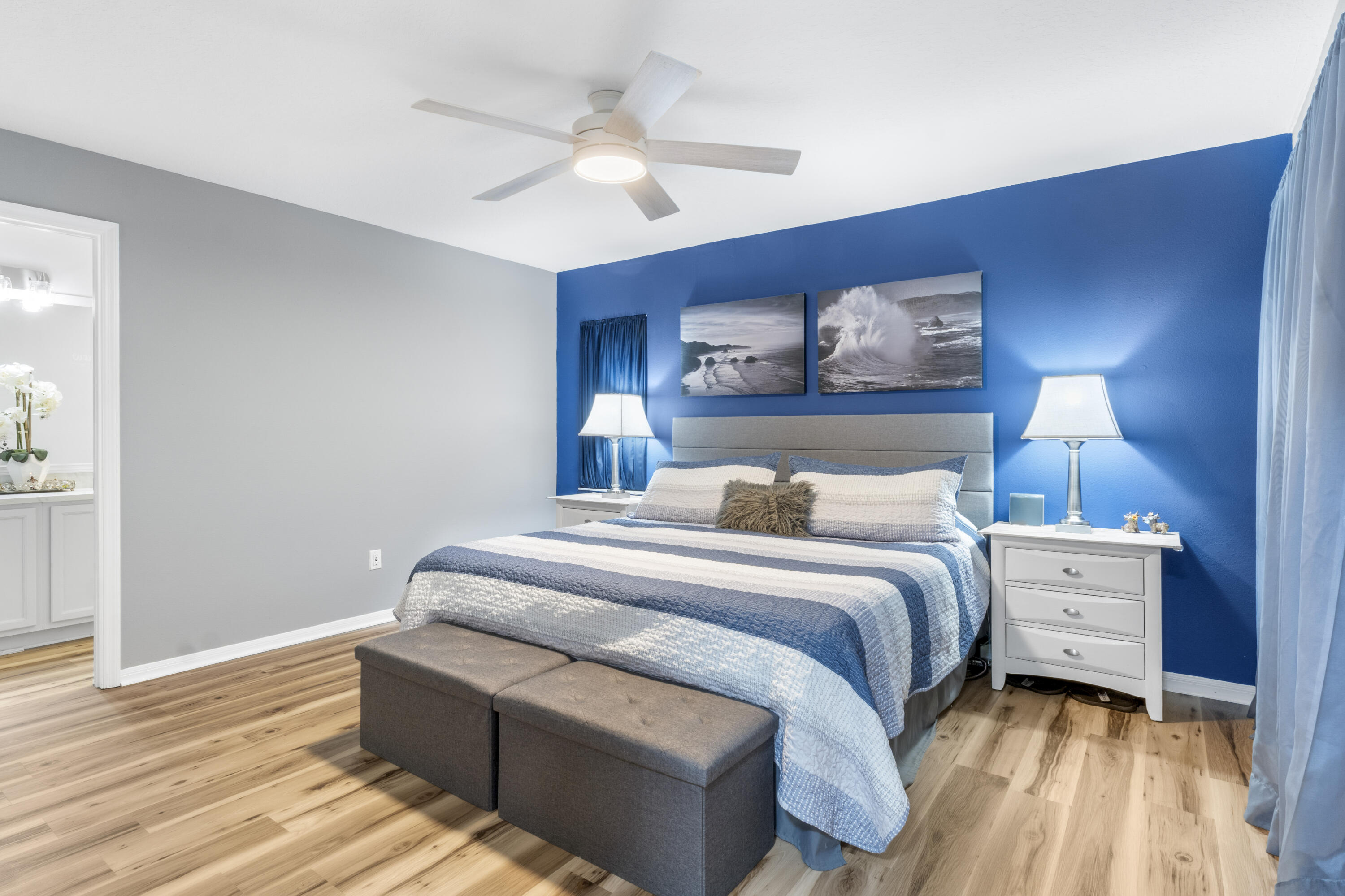 789 Vocelle Avenue Sebastian, FL 32958 - Photo 17 of 37 a bedroom with bed and paintings on the wall