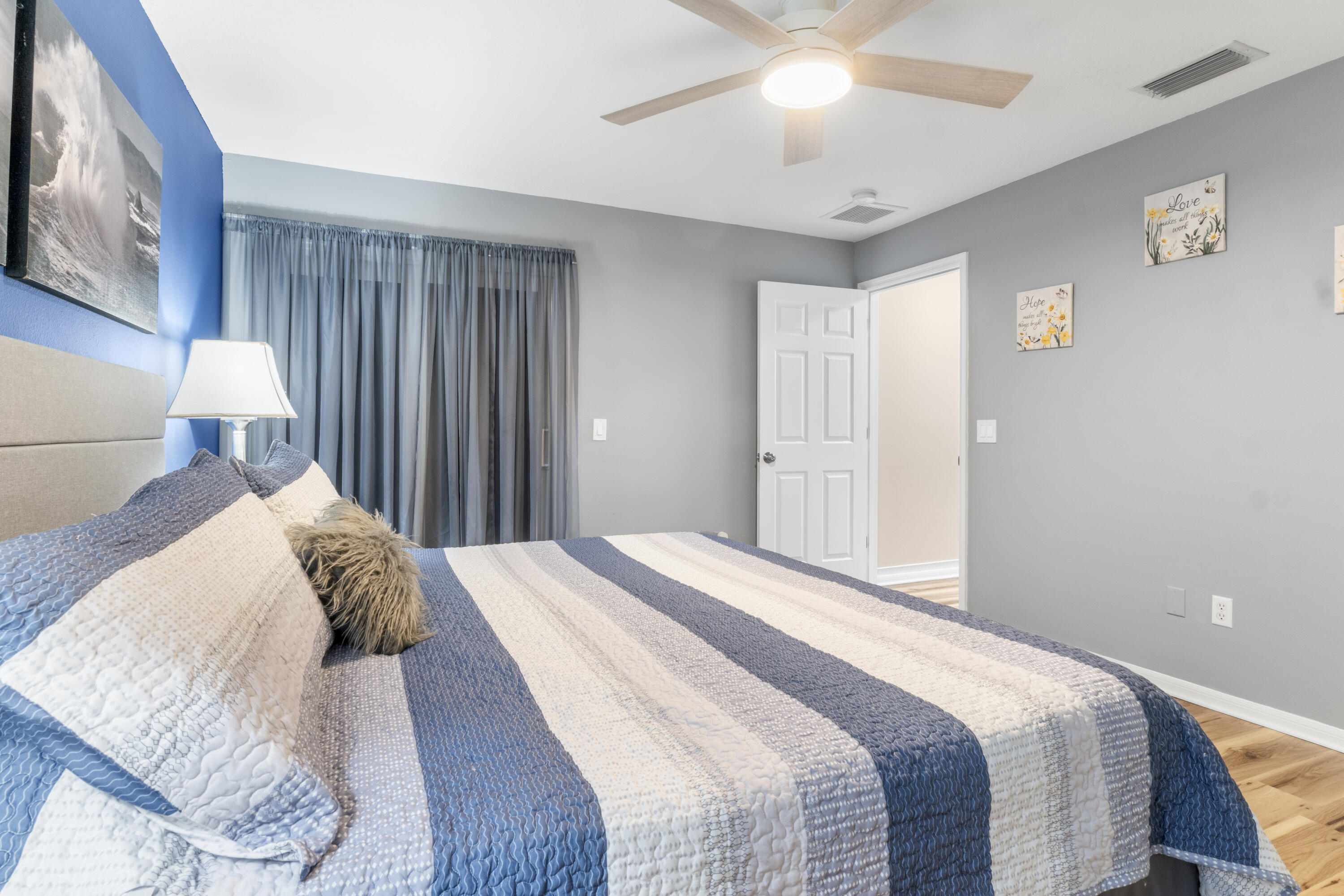 789 Vocelle Avenue Sebastian, FL 32958 - Photo 18 of 37 a bedroom with a bed and a lamp