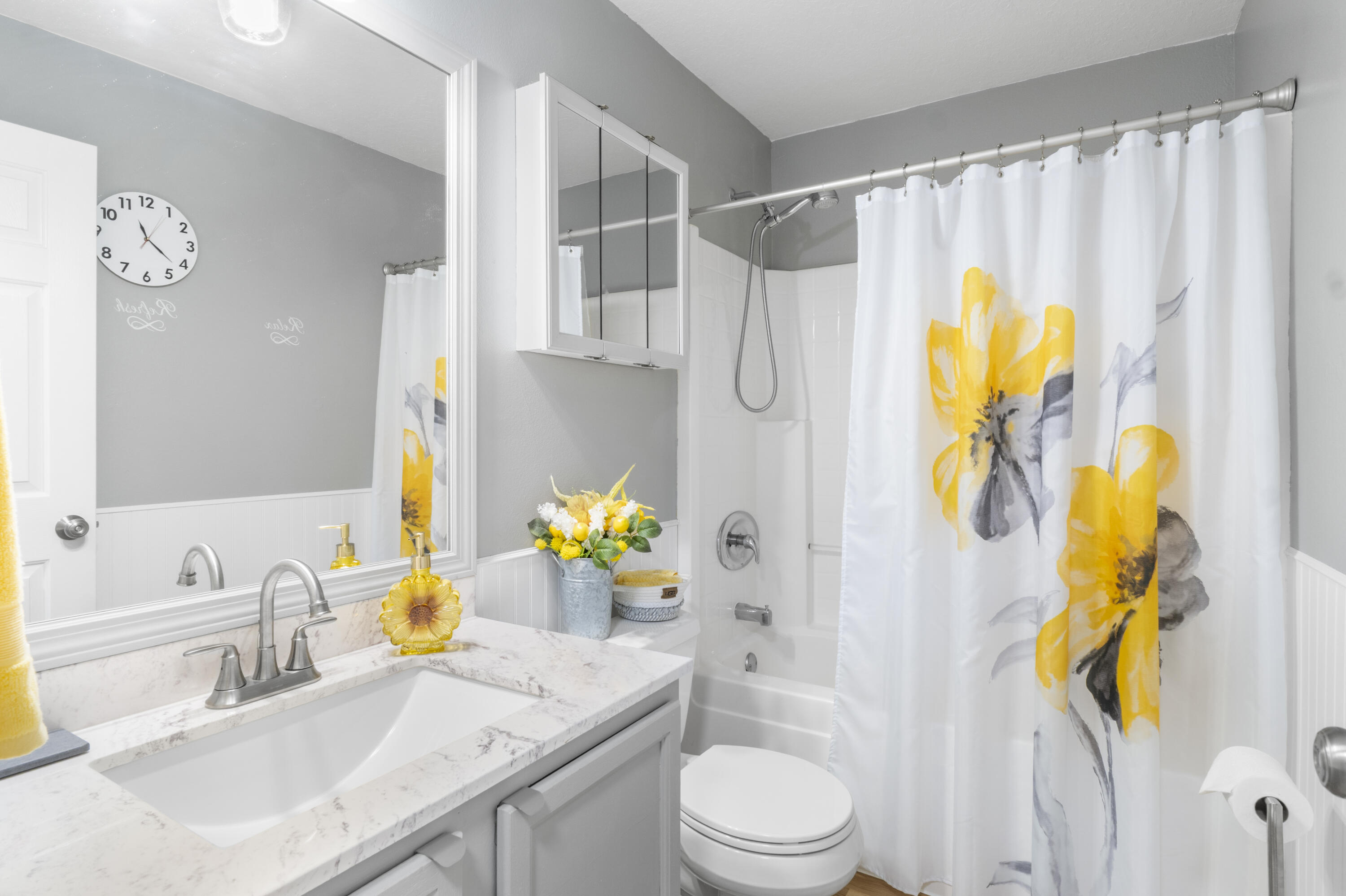 789 Vocelle Avenue Sebastian, FL 32958 - Photo 23 of 37 a bathroom with a granite countertop sink a toilet and a shower curtain