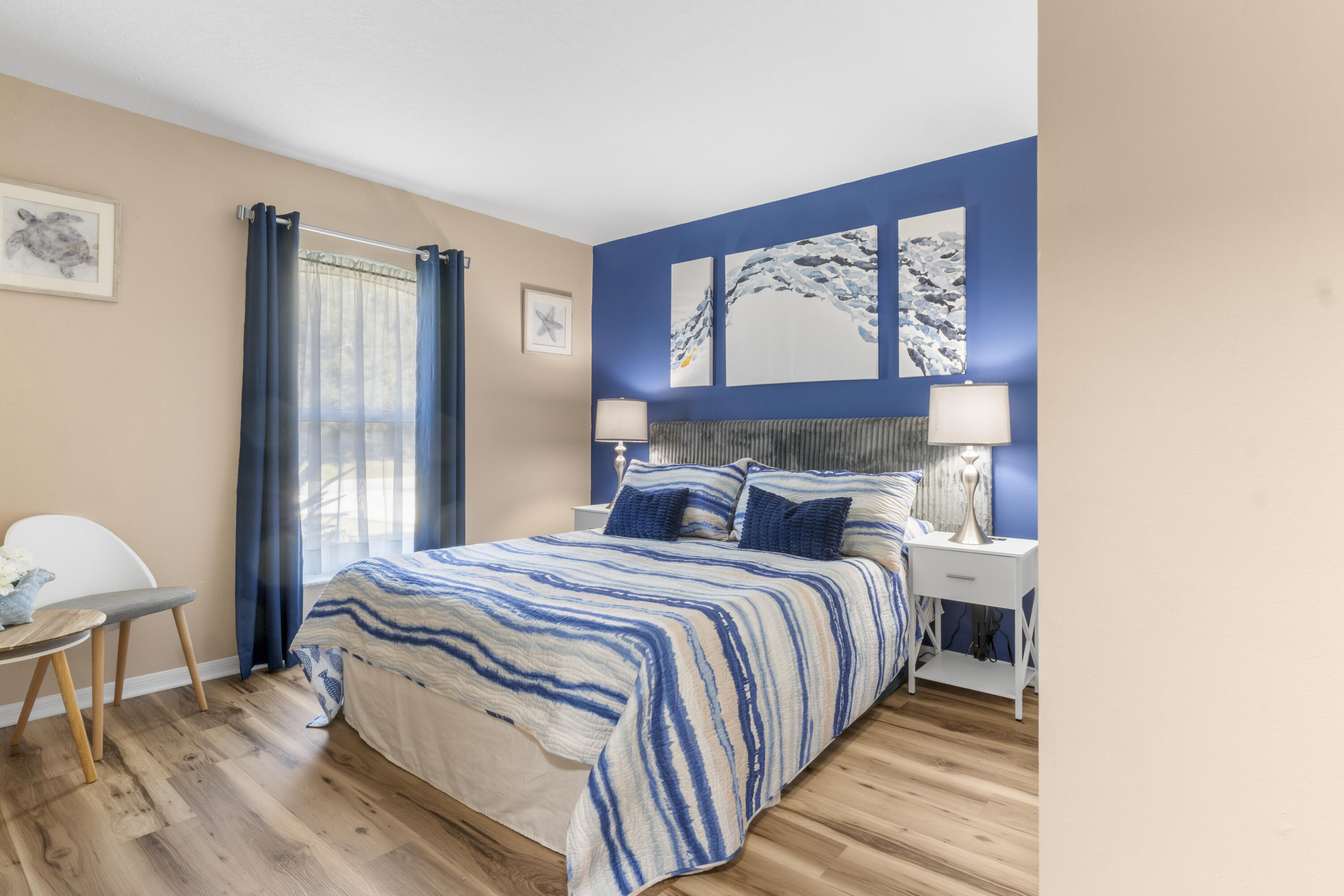 789 Vocelle Avenue Sebastian, FL 32958 - Photo 25 of 37 a bedroom with a bed a dresser and wooden floor