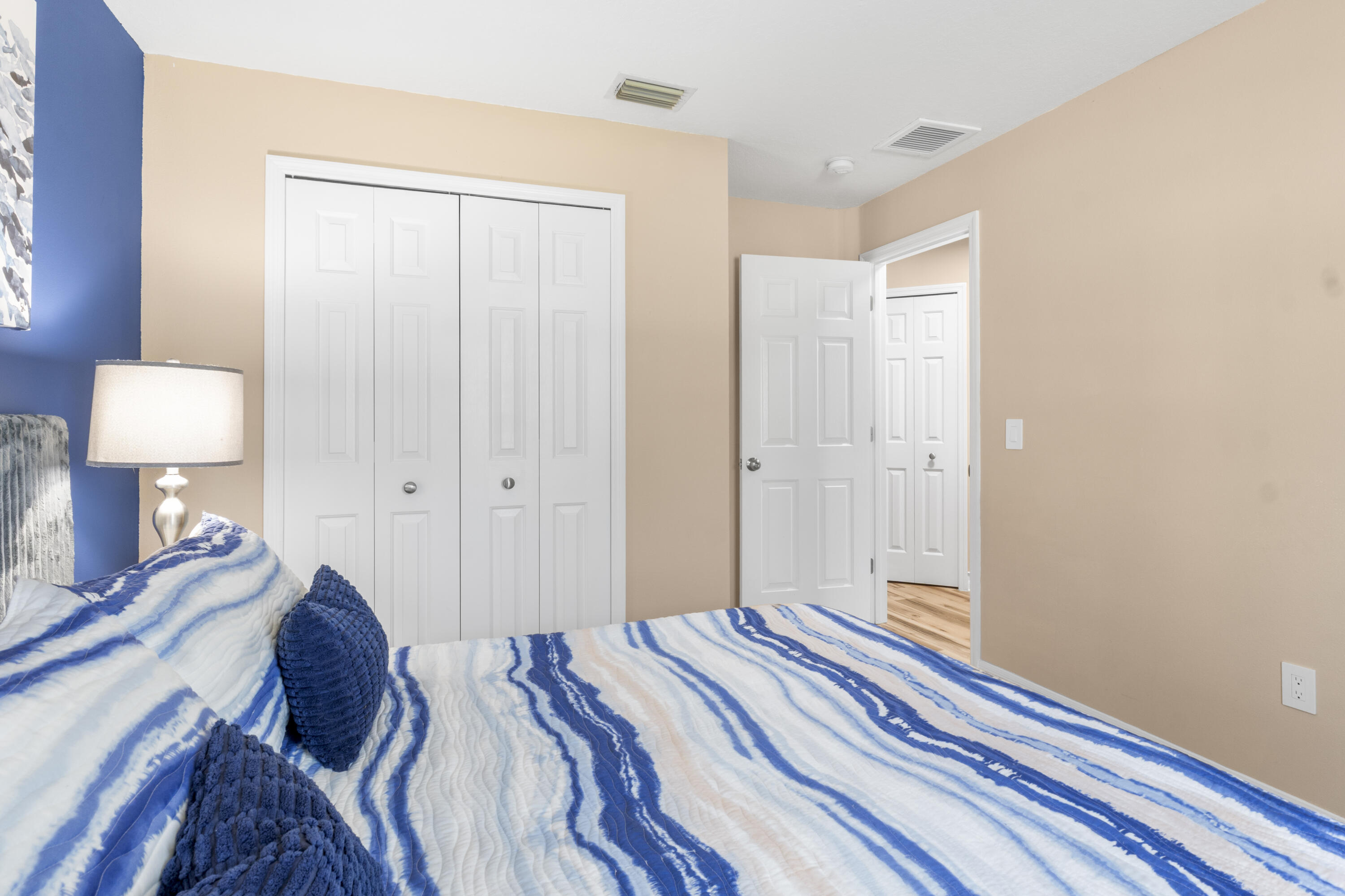 789 Vocelle Avenue Sebastian, FL 32958 - Photo 26 of 37 a bedroom with a bed and a lamp