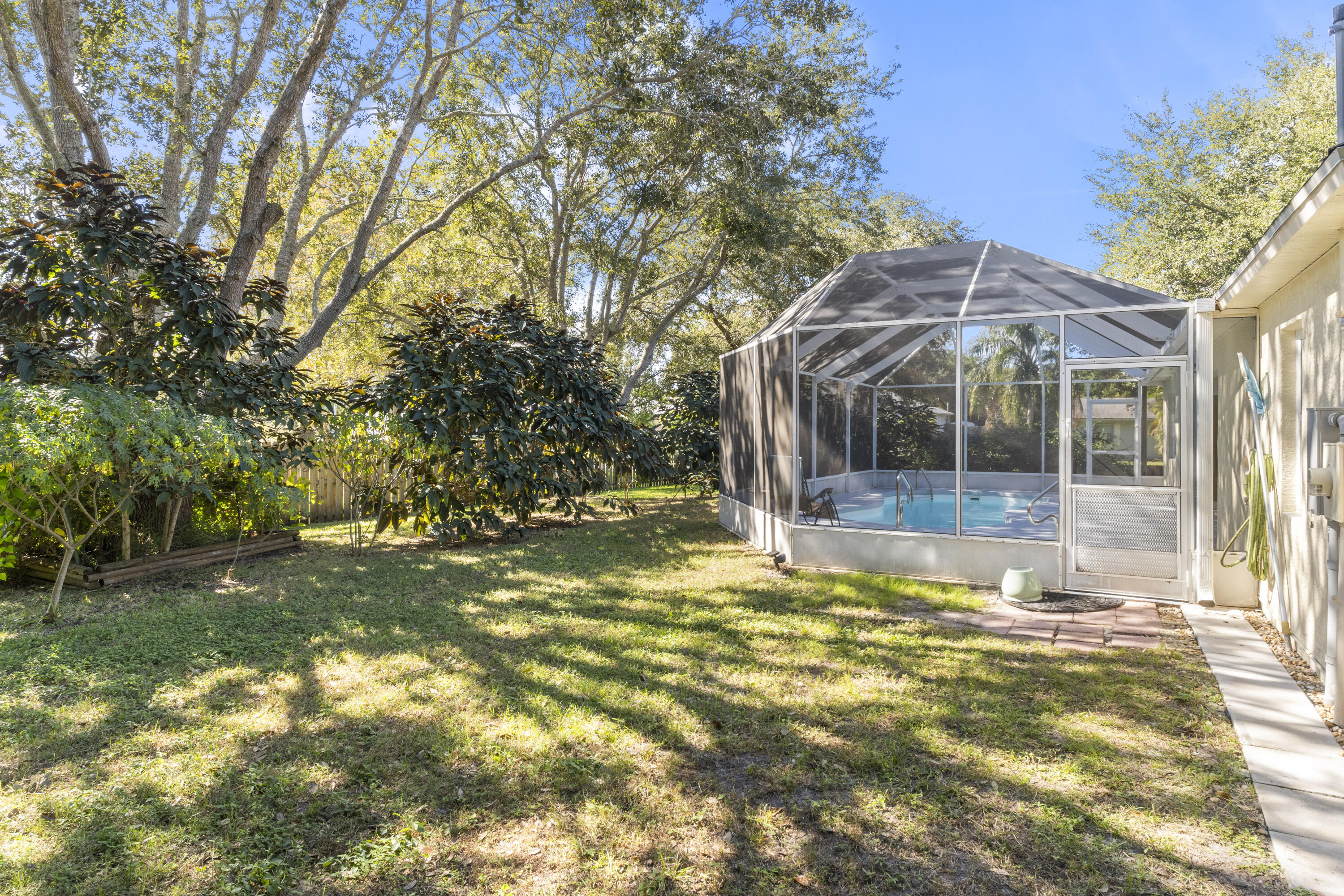 789 Vocelle Avenue Sebastian, FL 32958 - Photo 34 of 37 a view of a house with a large tree and a yard