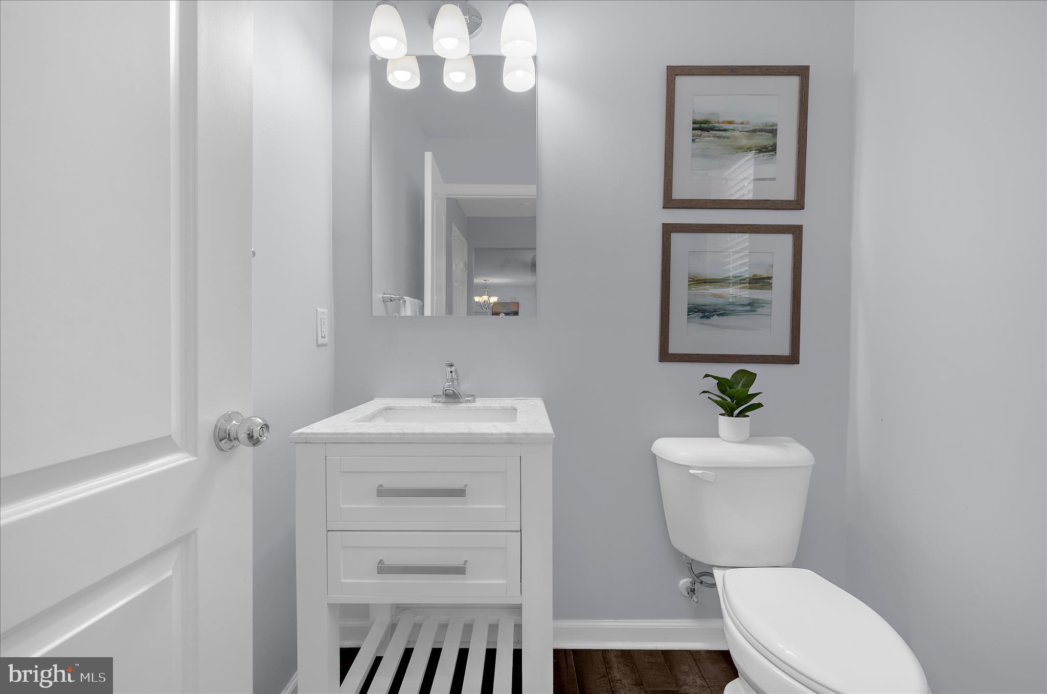 3009 Noahs Way Pasadena, MD 21122 - Photo 17 of 44 a bathroom with a sink a toilet and mirror