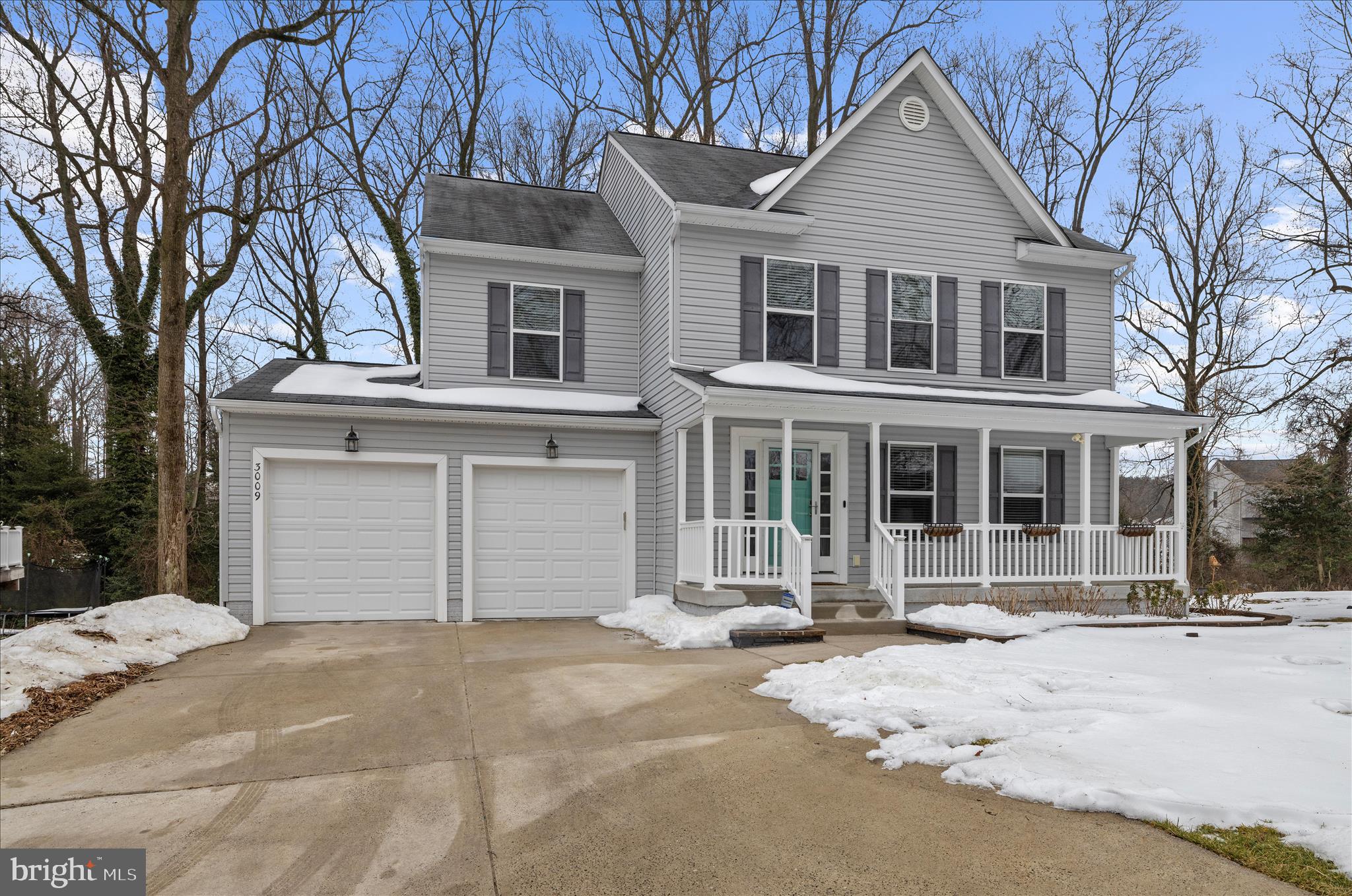 3009 Noahs Way Pasadena, MD 21122 - Photo 2 of 44 a front view of a house with a yard covered in snow