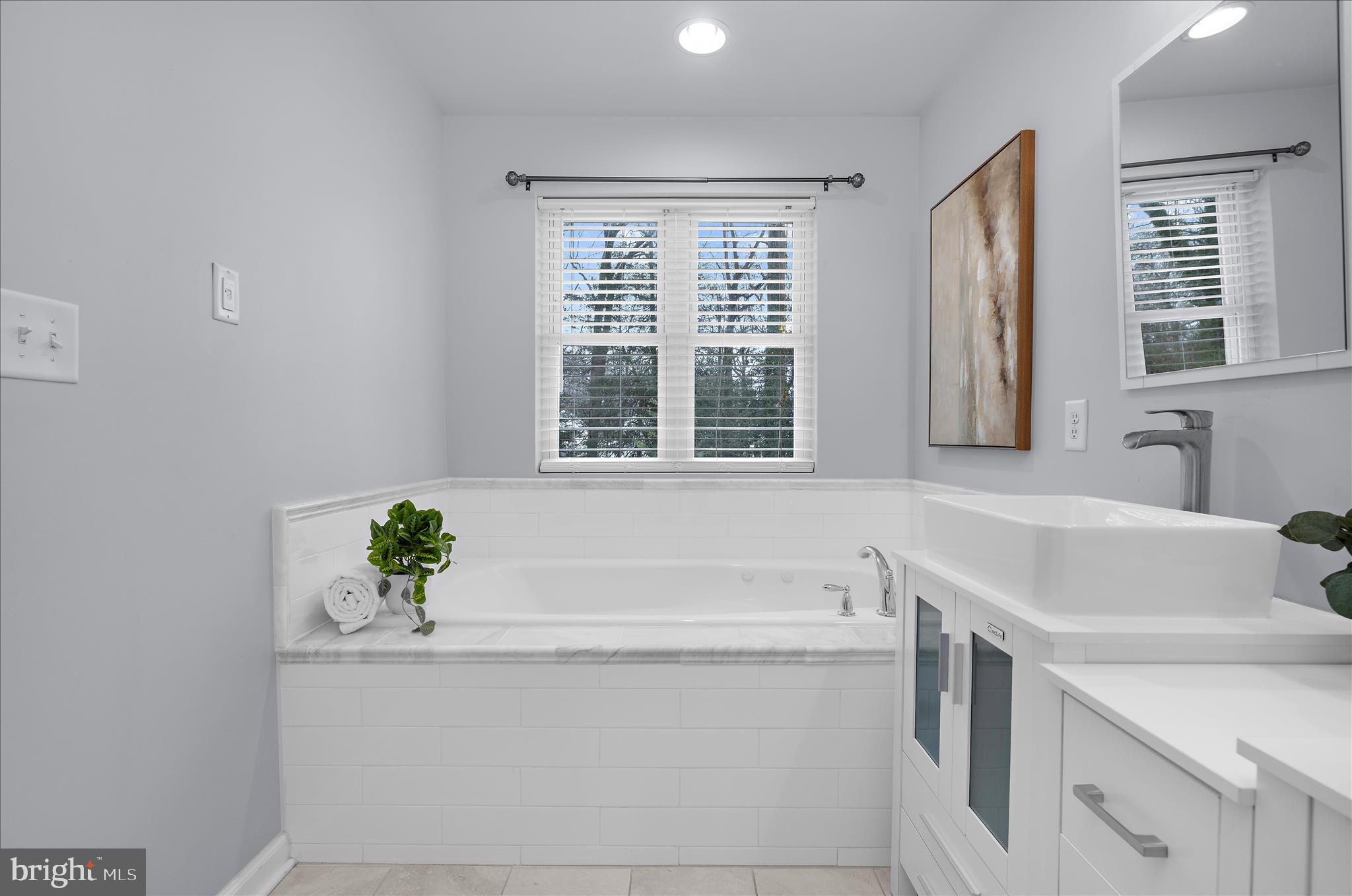 3009 Noahs Way Pasadena, MD 21122 - Photo 22 of 44 a bathroom with a tub sink and mirror