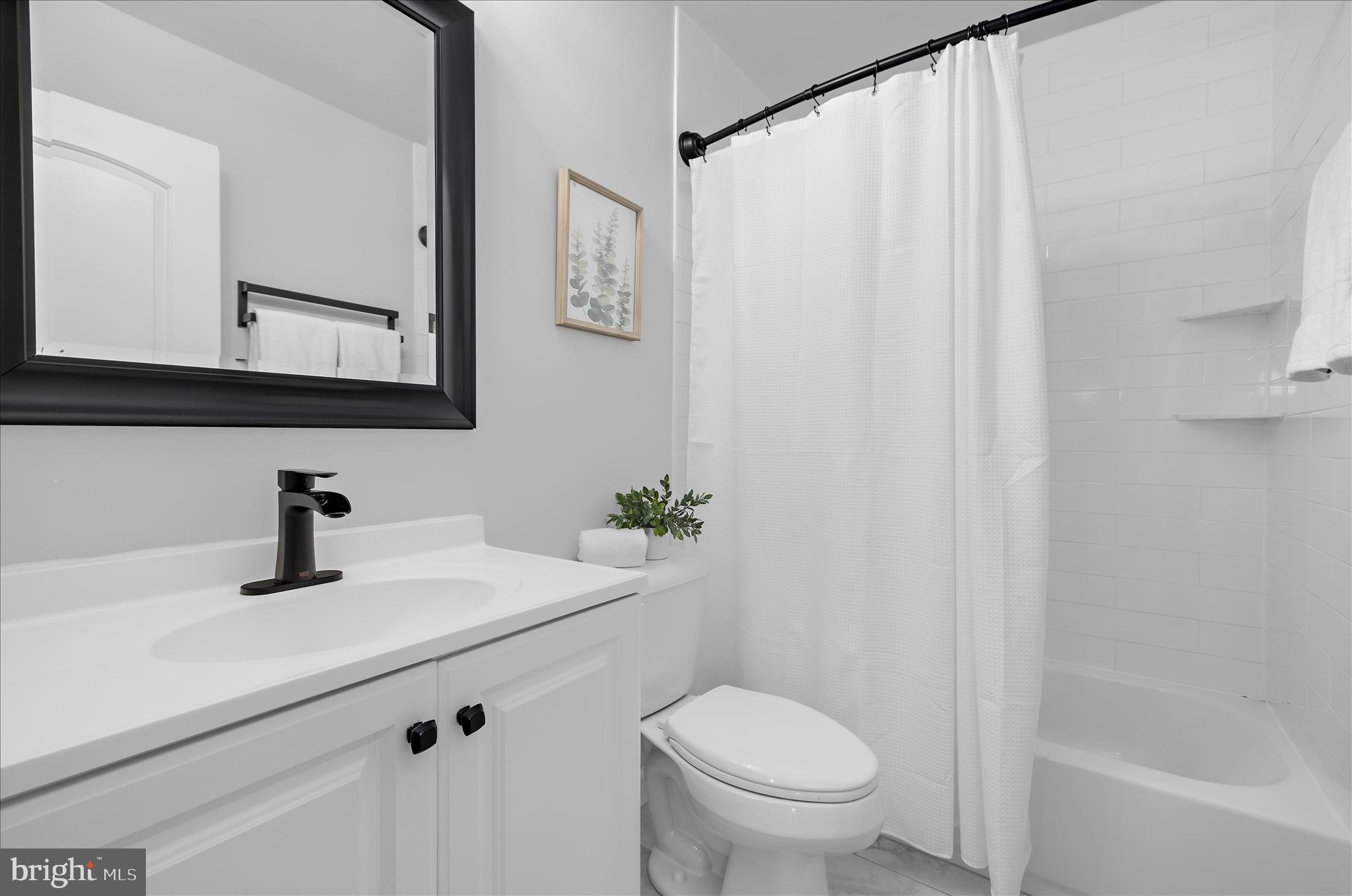 3009 Noahs Way Pasadena, MD 21122 - Photo 23 of 44 a bathroom with a sink a toilet and a mirror