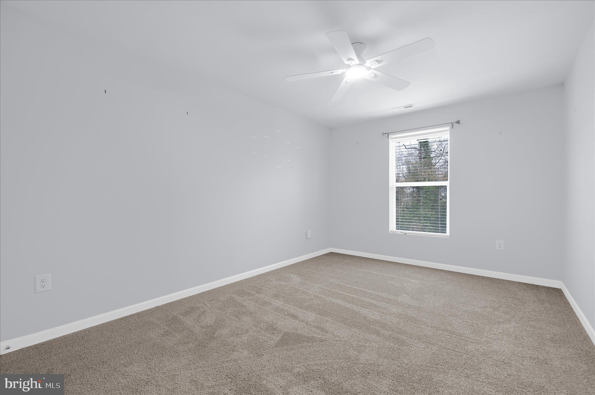 3009 Noahs Way Pasadena, MD 21122 - Photo 27 of 44 an empty room with windows and chandelier fan