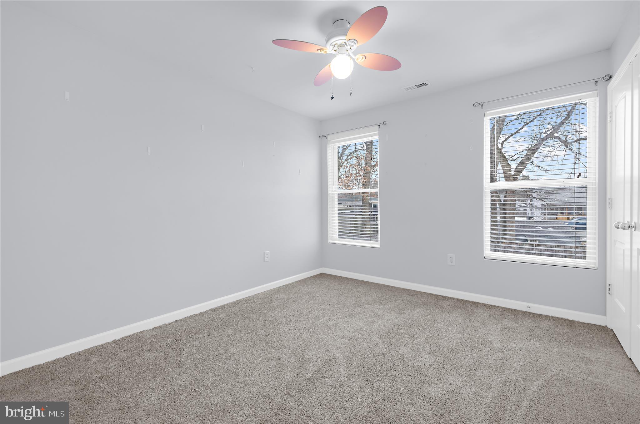 3009 Noahs Way Pasadena, MD 21122 - Photo 29 of 44 an empty room with windows and fan