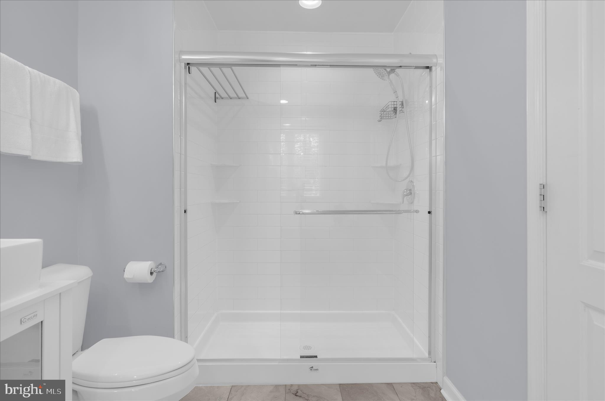3009 Noahs Way Pasadena, MD 21122 - Photo 33 of 44 a bathroom with a shower a toilet and a sink