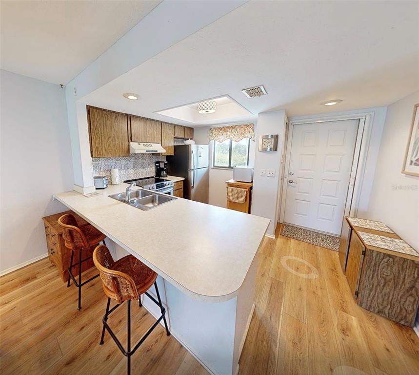 25225 Rampart Boulevard, Unit 105 Punta Gorda, FL 33983 - Photo 16 of 40 a view of a dining room with furniture window and wooden floor