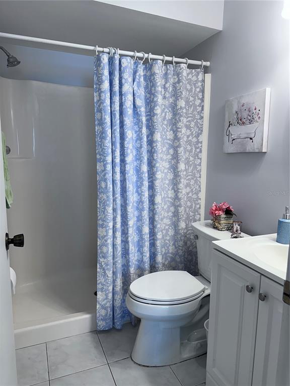 25225 Rampart Boulevard, Unit 105 Punta Gorda, FL 33983 - Photo 20 of 40 a bathroom with a toilet and a shower curtain