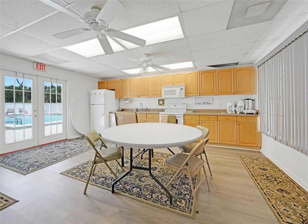 25225 Rampart Boulevard, Unit 105 Punta Gorda, FL 33983 - Photo 35 of 40 a dining room with a table and chairs