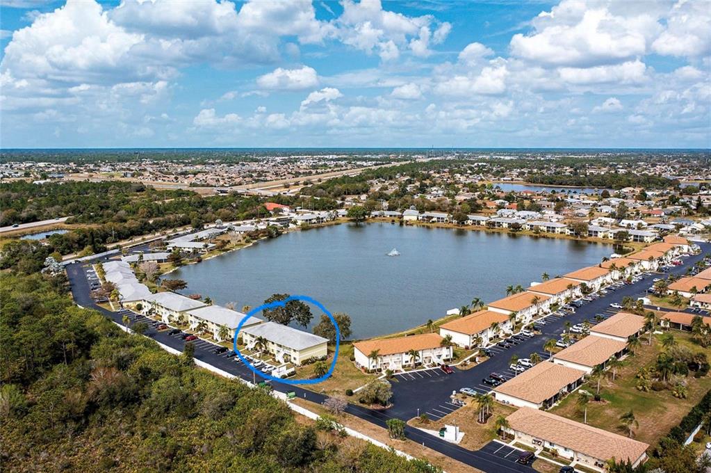 25225 Rampart Boulevard, Unit 105 Punta Gorda, FL 33983 - Photo 4 of 40 an aerial view of a city with lots of residential buildings ocean and mountain view in back