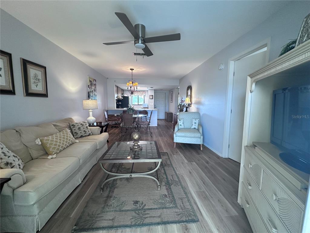 25225 Rampart Boulevard, Unit 105 Punta Gorda, FL 33983 - Photo 8 of 40 a living room with furniture and a wooden floor