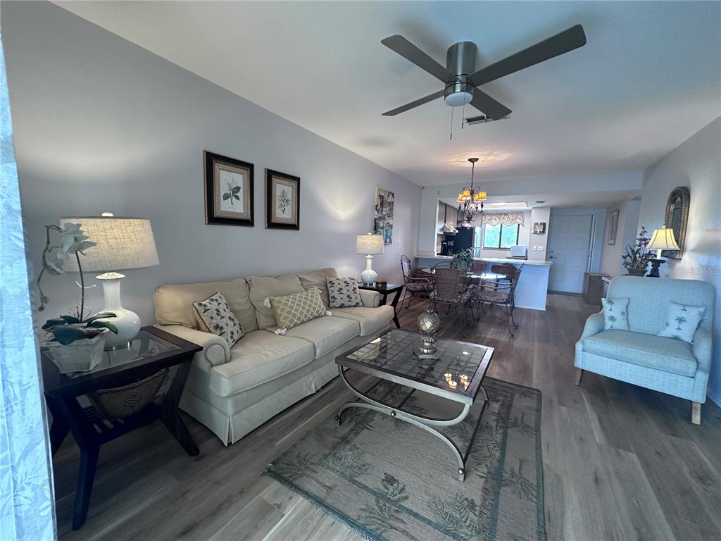 25225 Rampart Boulevard, Unit 105 Punta Gorda, FL 33983 - Photo 9 of 40 a living room with furniture and a wooden floor