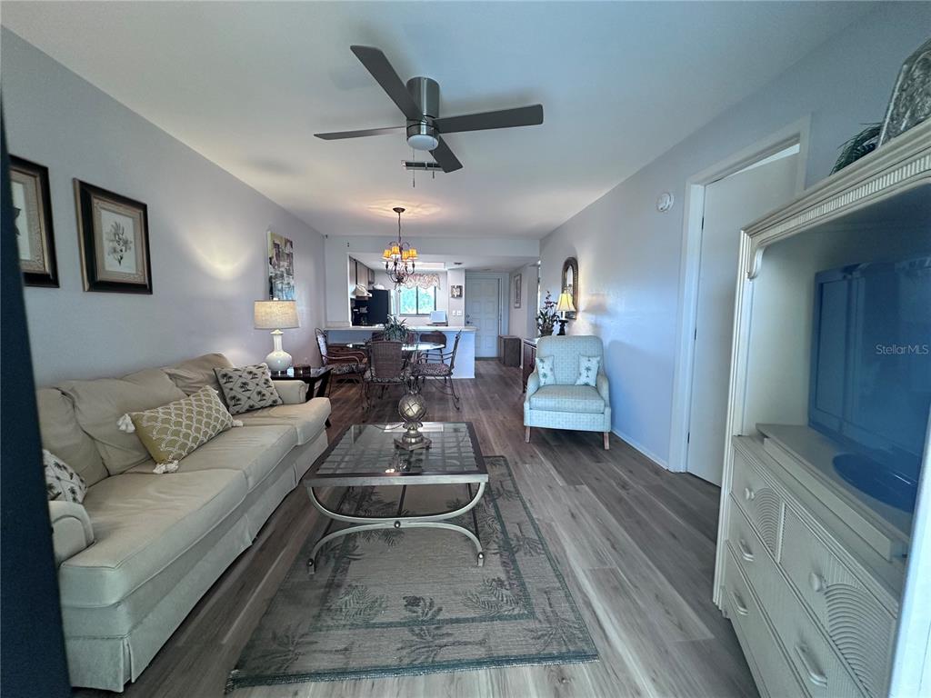 25225 Rampart Boulevard, Unit 105 Punta Gorda, FL 33983 - Photo 10 of 40 a living room with furniture and a wooden floor