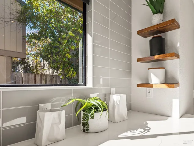 a white vase of flowers sitting on a table