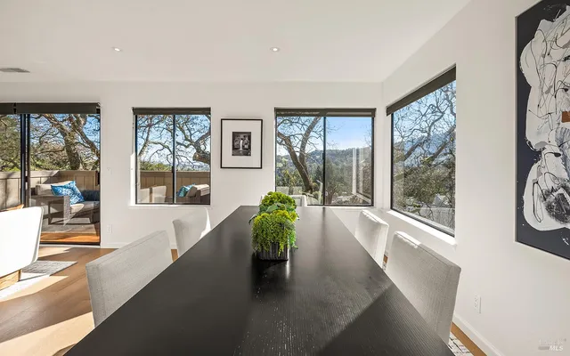 a view of a living room with furniture and large windows