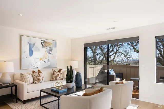 a living room with furniture a large window and a flat screen tv