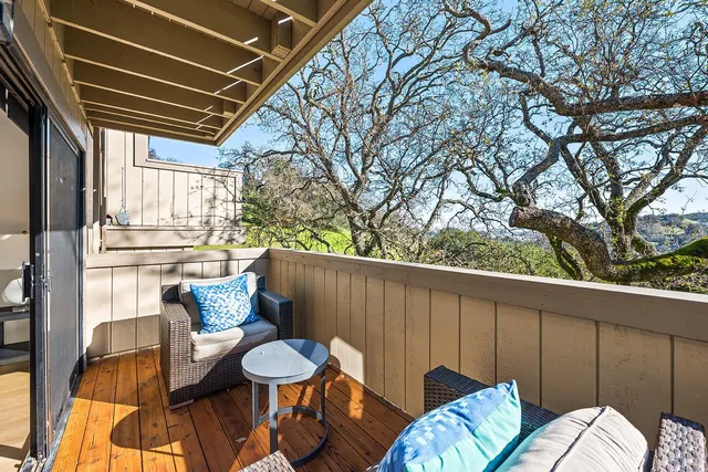 a view of a balcony with chairs and a table