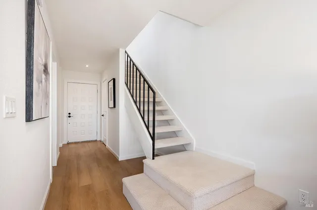 a view of entryway and hall with wooden floor