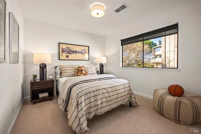 a bedroom with a bed and a large window