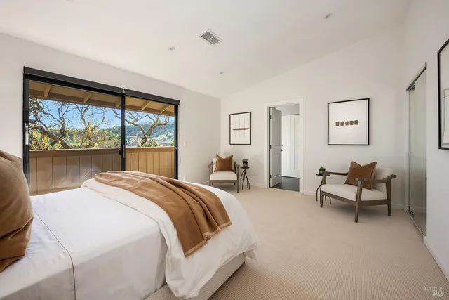 a bedroom with a bed and a large window