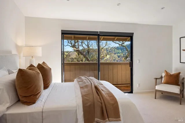 a bedroom with a bed and a large window