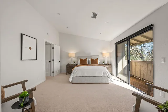 a spacious bedroom with a large bed and a large window