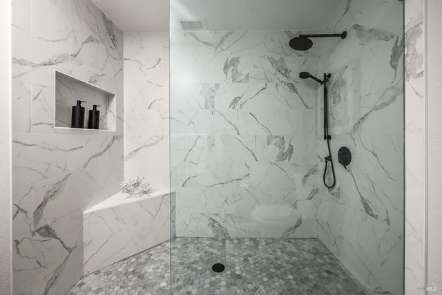 a bathroom with a double vanity sink and a window