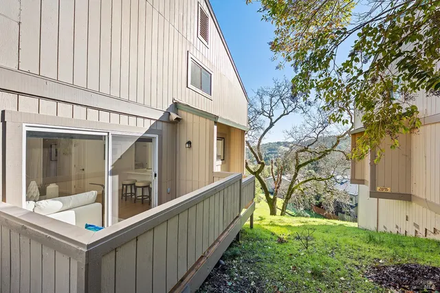an aerial view of house with yard and ocean view