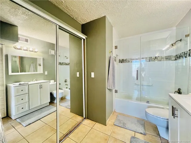 a spacious bathroom with a shower sink and mirror
