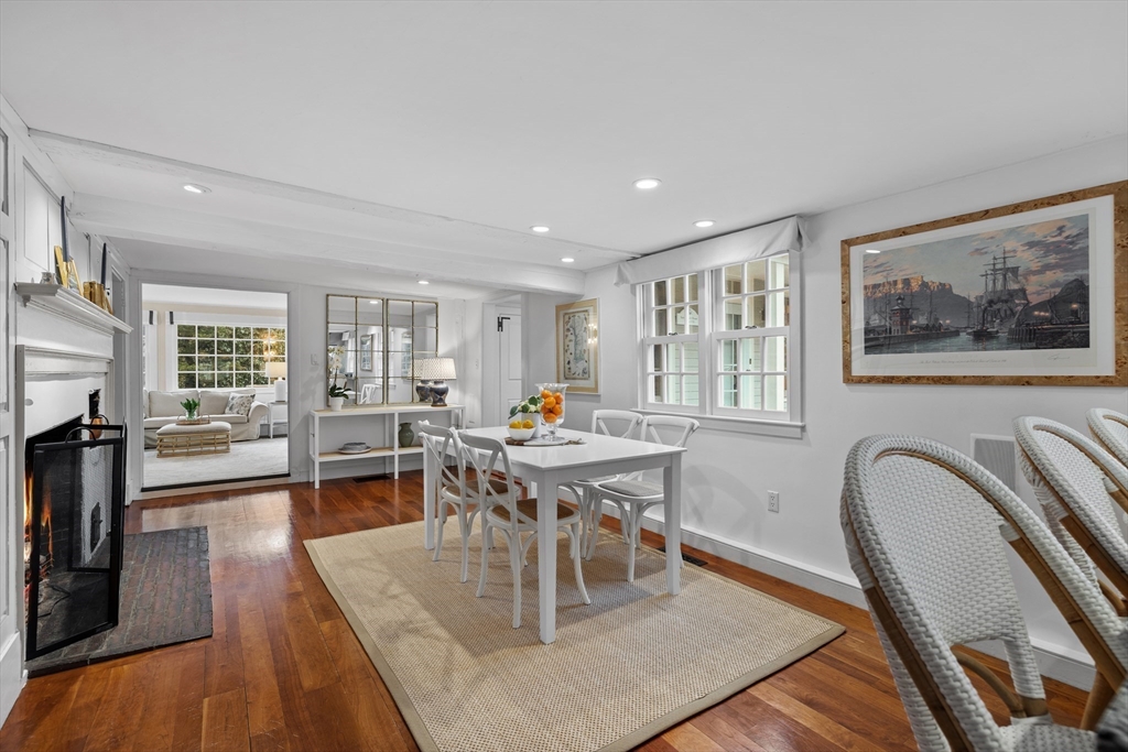173 Holt Road Andover, MA 01810 - Photo 6 of 33 a living room with furniture a dining table and a fireplace