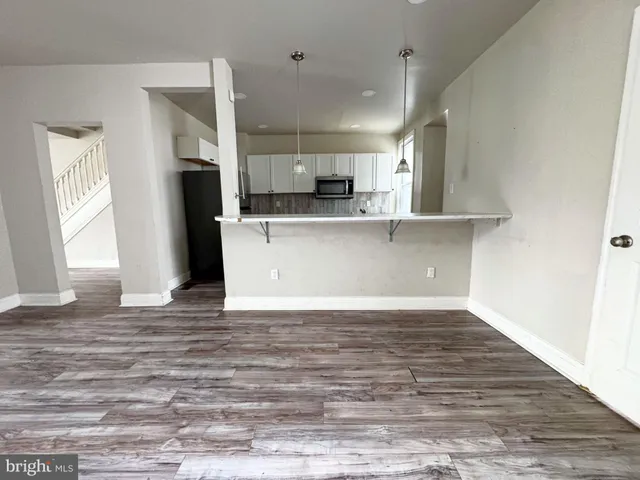 a view of kitchen with stainless steel appliances kitchen island a refrigerator sink and stove