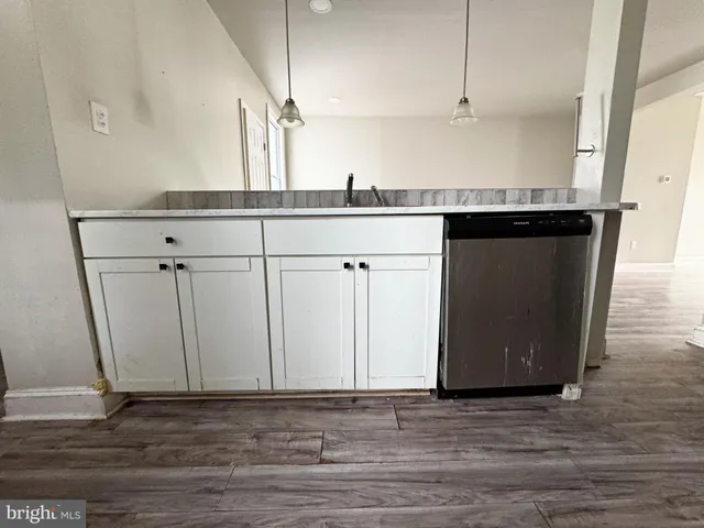 a kitchen with a sink and cabinets