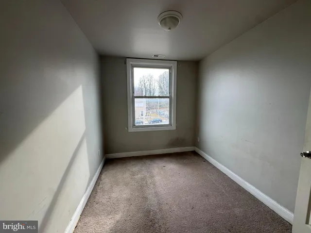 a view of an empty room and closet area