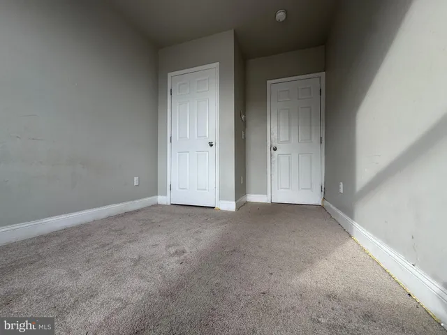 a view of a blue house with a street