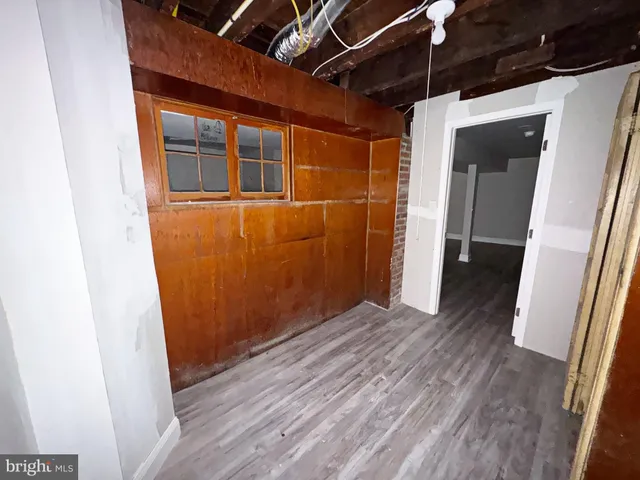 a view of a hallway with wooden floor and stairs
