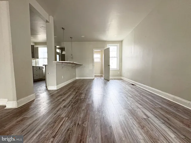 a view of a kitchen with a sink and a refrigerator