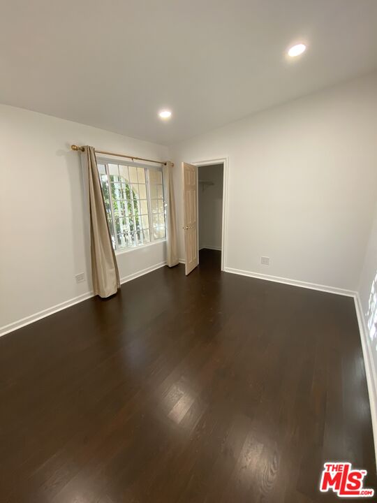 3900 Castlerock Road Malibu, CA 90265 - Photo 12 of 52 an empty room with wooden floor and windows