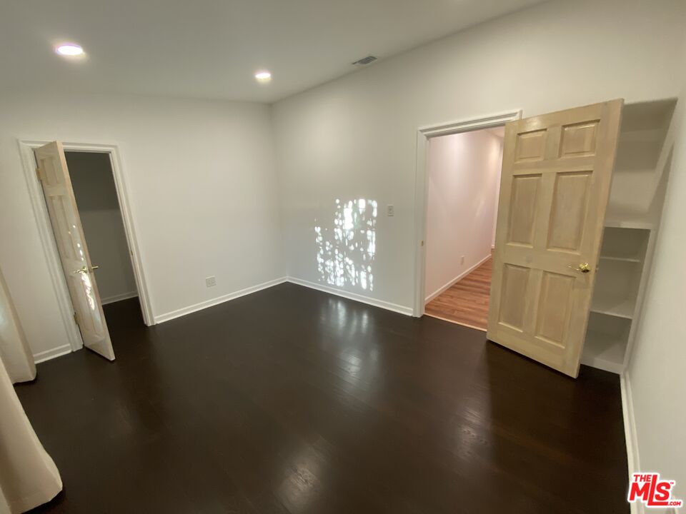 3900 Castlerock Road Malibu, CA 90265 - Photo 13 of 52 an empty room with wooden floor and windows