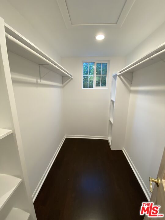 3900 Castlerock Road Malibu, CA 90265 - Photo 16 of 52 an empty room with wooden floor and windows
