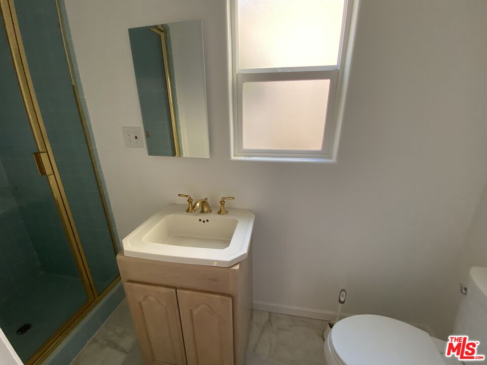 3900 Castlerock Road Malibu, CA 90265 - Photo 22 of 52 a bathroom with a sink toilet and mirror