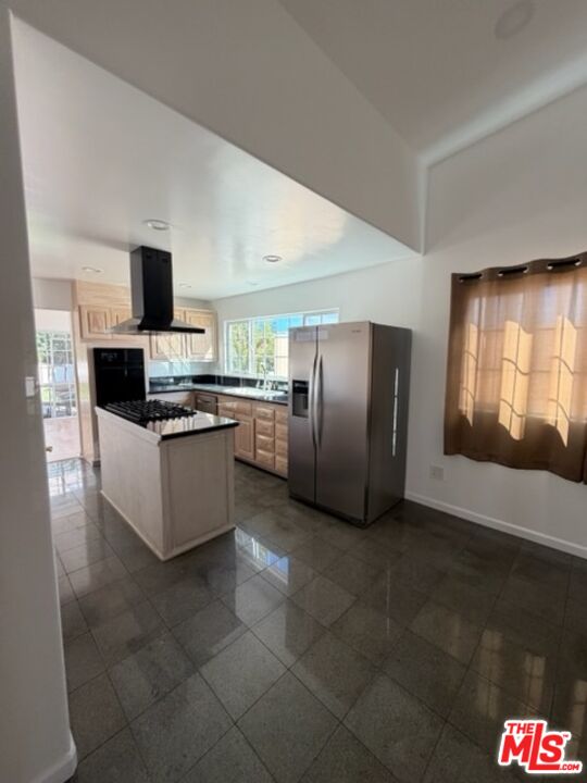 3900 Castlerock Road Malibu, CA 90265 - Photo 29 of 52 a large kitchen with stainless steel appliances kitchen island granite countertop a refrigerator and a stove top oven